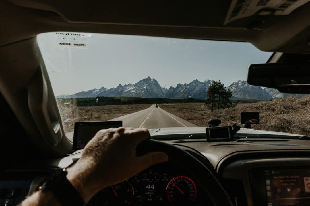 View of car and highway road from front windshield