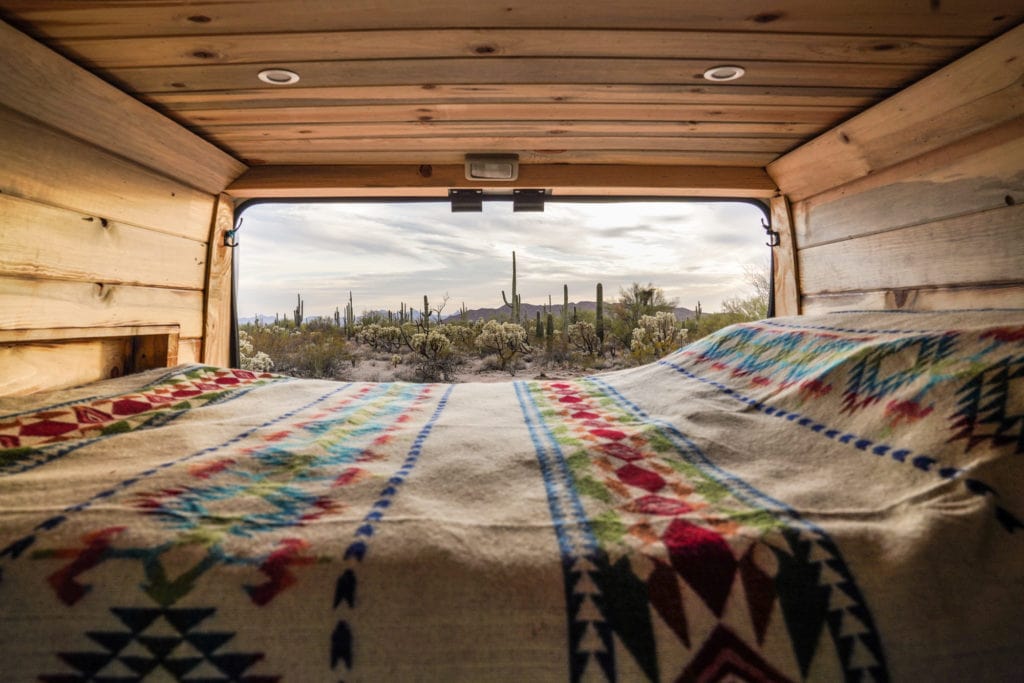 Campervan rental bed setup in desert