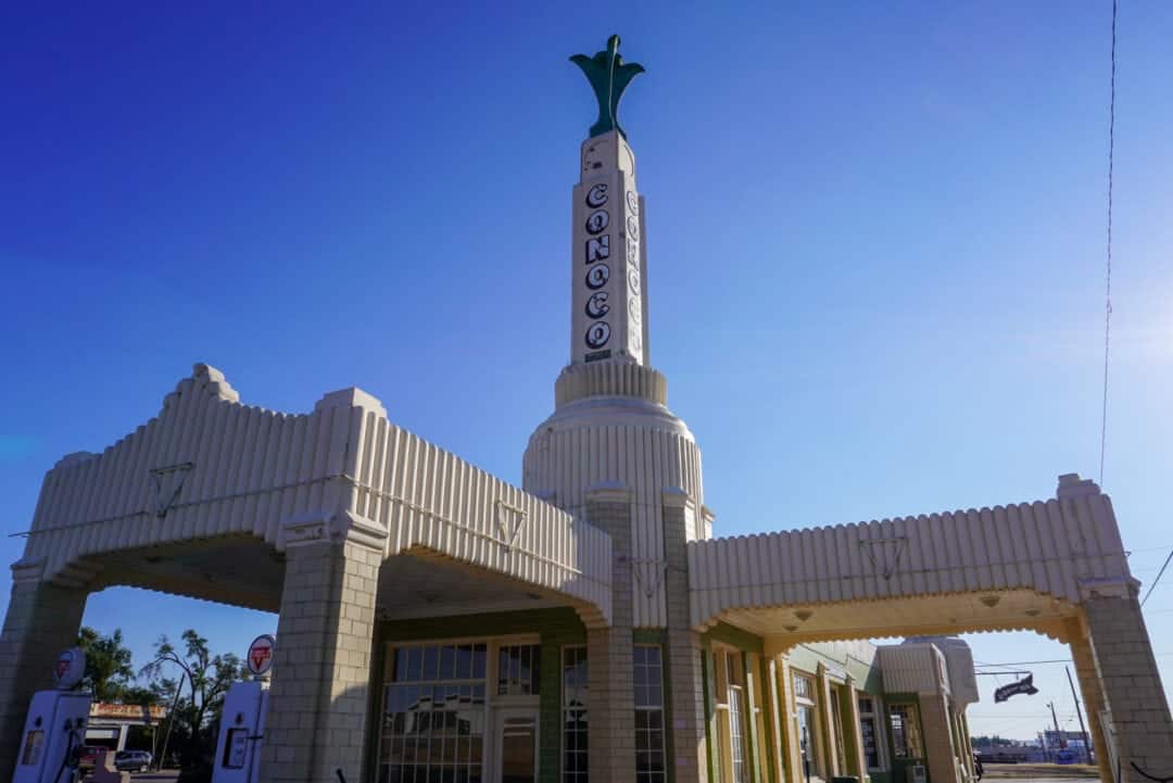 A tall spider-like art-deco building against a blue sky