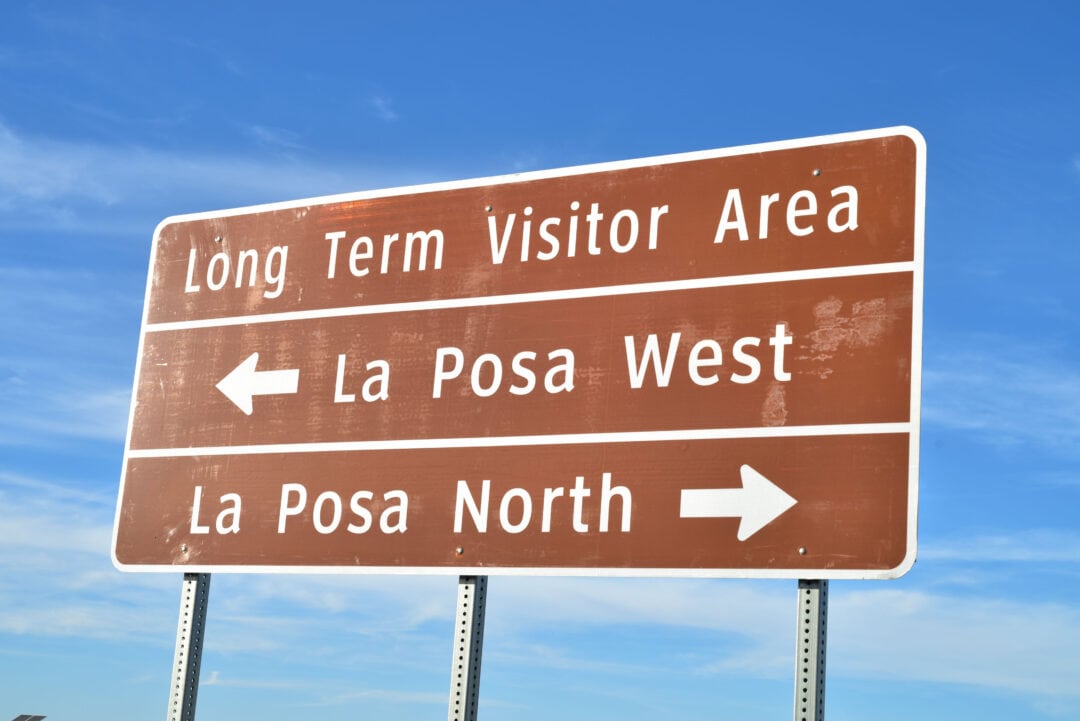 A roadside sign points out directions to La Posa.